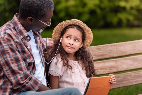 grandchild listening to music with grandfather