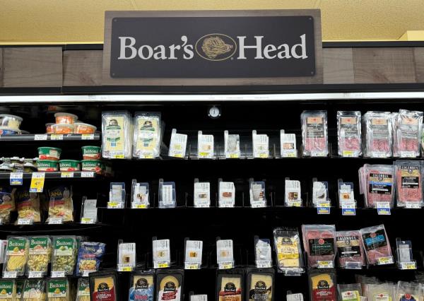 Empty supermarket shelves normally stocked with Boar's Head meats due to a recall.