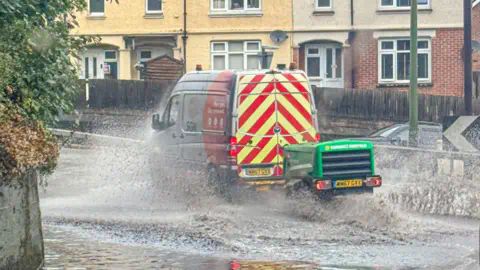 BBC Weather Watchers/StormChaserLiam   A van driving through a large puddle