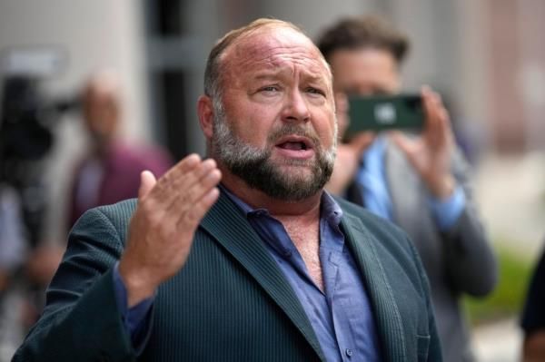 Alex Jones speaks to the media after arriving at the federal courthouse for a hearing in front of a bankruptcy judge, June 14, 2024